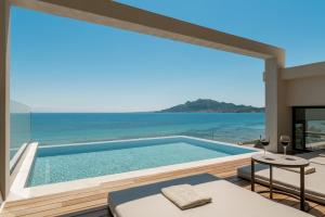 a pool with a view of the ocean from a house at Nerea Deluxe SeaFront Villa, Iconic Infinity Pool, By ThinkVilla in Zakynthos
