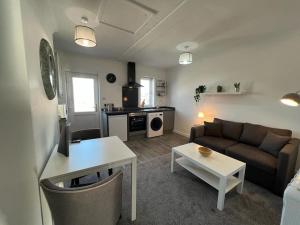 a living room with a couch and a table at Flat 2 High Street Apartments, One Bed in Wellington