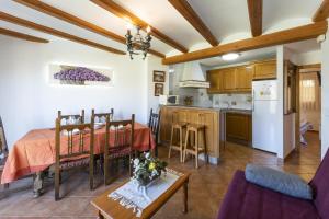 a kitchen and a dining room with a table in a room at Carrebaix IV in Orba