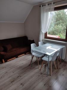 a living room with a table and chairs and a couch at AsPa in Ostrowo