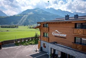 a building with a sign on the side of it at Klawunn Hotel & Apartement in Kaprun