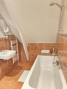 a bathroom with a bath tub and a sink at CN-Hotel in Arnhem