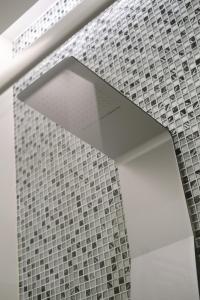 a room with a wall of tiles on the wall at Domea Superior Rooms Bed and Breakfast in Reggio Calabria