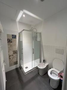 a bathroom with a shower and a toilet and a sink at Suite The Brick in Turin
