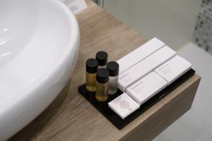 a table with three bottles of essential oils on it at Domea Superior Rooms Bed and Breakfast in Reggio Calabria