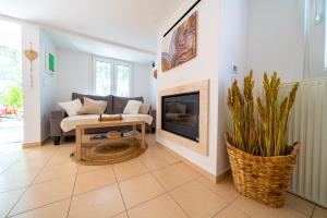 a living room with a couch and a fireplace at Little Villa - walk to the beach in Thessaloniki +22 photos