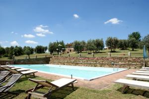 a swimming pool with lounge chairs and a resort at Casa Elisabetta in Limite