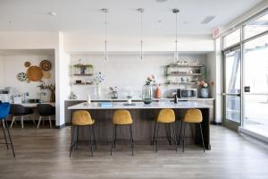 a kitchen with a large island with stools at Arlington Heights 2br w wd gym bbq nr dining CHI-911 in Arlington Heights