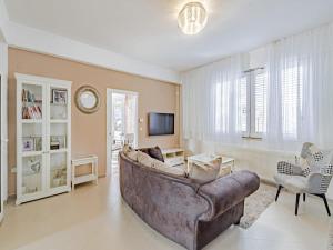 a large living room with a couch and a tv at Villa Ponar in Kučište
