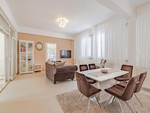 a living room with a table and chairs and a couch at Villa Ponar in Kučište