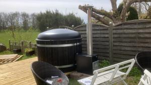 a trash can sitting on a deck next to a fence at Munkebergs gård in Kristianstad