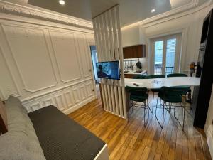 a living room with a table and chairs in a room at Le Sarciron 207 Le Mont Dore in Le Mont-Dore