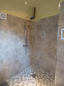 a shower with a glass door in a bathroom at Cosy Studio Cottage in Lincoln