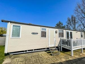a mobile home with a porch and a ladder at Brilliant 8 Berth Caravan With Decking At Haven Caister Beach Ref 30055p in Great Yarmouth