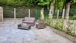 two chairs and a table on a patio at Troubadour24 in Poperinge