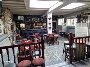 a bar with tables and chairs in a restaurant at Bounty Bar in Trim