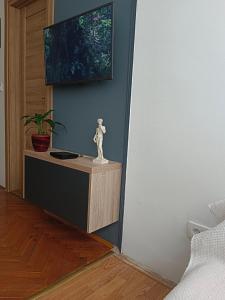 a living room with a tv on a wall at Dena apartman Tivat in Tivat
