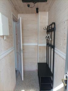 a room with a closet with a black bench in it at Oakcorner Place Apartment in Haapsalu