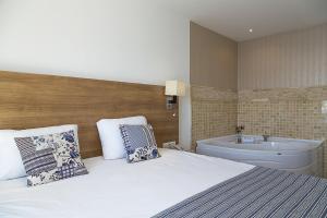 A bed or beds in a room at Rhapsody Hotel Kas
