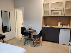 a kitchen with a table and chairs in a room at H7 TLV in Tel Aviv