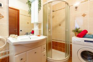 ein Badezimmer mit einem Waschbecken und einer Waschmaschine in der Unterkunft Appartamento Margherita Plus - MyHo Casa in Vieste