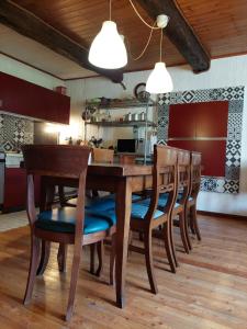 a dining room with a wooden table and chairs at casa Fiorella in Mattie
