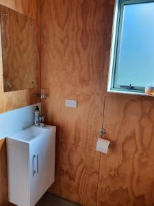 a bathroom with a sink and a window at Beautiful Rural Oasis in Upper Hutt