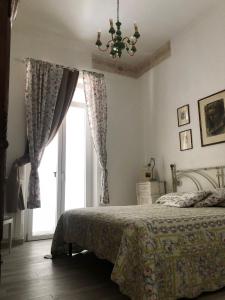 a bedroom with a bed and a large window at Via Puccini 217 in Viareggio