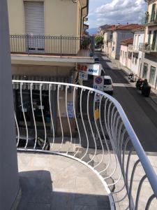 a metal railing on a balcony with a street at Via Puccini 217 in Viareggio