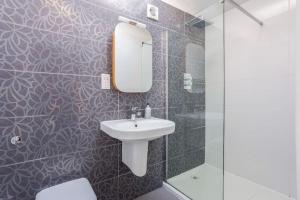 a bathroom with a sink and a mirror and a shower at Family home close to Bournemouth town centre in Bournemouth +20 photos
