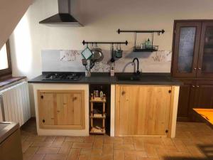 a kitchen with a sink and a stove top oven at La casetta in Ferentillo