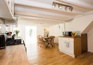 a kitchen and living room with a table and chairs at 118 High Street in Kirkcudbright