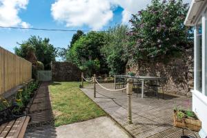 a garden with a table and a fence at 118 High Street in Kirkcudbright