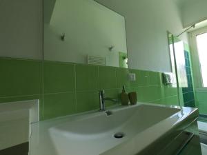 a bathroom with a sink and a large mirror at Mary's House in Rome