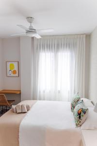 a bedroom with a large white bed with a window at NEW Stylish 2 Bedroom Apt in Las Palmas de Gran Canaria