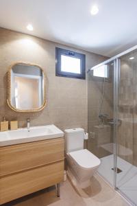 a bathroom with a toilet and a sink and a shower at NEW Stylish 2 Bedroom Apt in Las Palmas de Gran Canaria