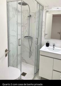a bathroom with a shower and a sink at Apartamento Feliz in Figueira da Foz
