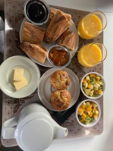 a tray of food with muffins and bread and fruit at La roche aux mouettes in Hyères