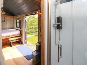 a shower in a tiny house with a bedroom at Malbec in Seaview