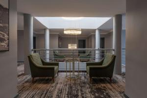 a lobby with chairs and a table and a chandelier at Park Inn by Radisson, Lagos Victoria Island in Lagos