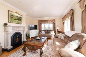 a living room with a couch and a fireplace at Cottage 419 - Carna in Carna