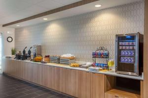 a cafeteria with a counter with food on it at Microtel Inn & Suites by Wyndham Liberty NE Kansas City Area in Liberty