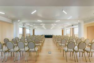 an empty room with a bunch of chairs in it at TRYP by Wyndham Porto Expo Hotel in Leça da Palmeira