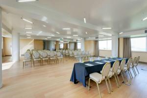 a conference room with a long table and chairs at TRYP by Wyndham Porto Expo Hotel in Leça da Palmeira