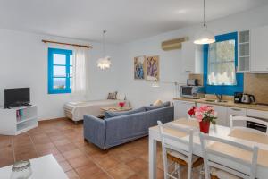 a living room with a couch and a table at Eleni Villas in Hersonissos