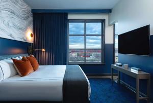 a hotel room with a bed and a large window at Dream Nashville in Nashville
