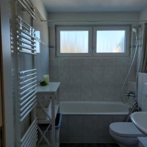 a bathroom with a tub and a toilet and a sink at Ferienwohnung Meeresrauschen in Graal-Müritz