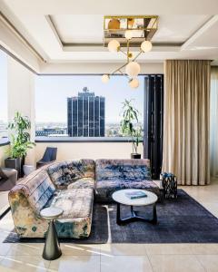 a living room with a couch and a table at Dream Hollywood, Part Of Hyatt in Los Angeles