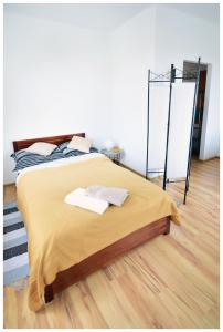 a bed with two towels on it in a room at Color24 Apartament VI in Stalowa Wola