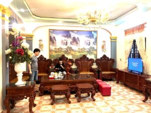 un homme debout dans un salon avec un canapé dans l'établissement HaiAu Hotel, 